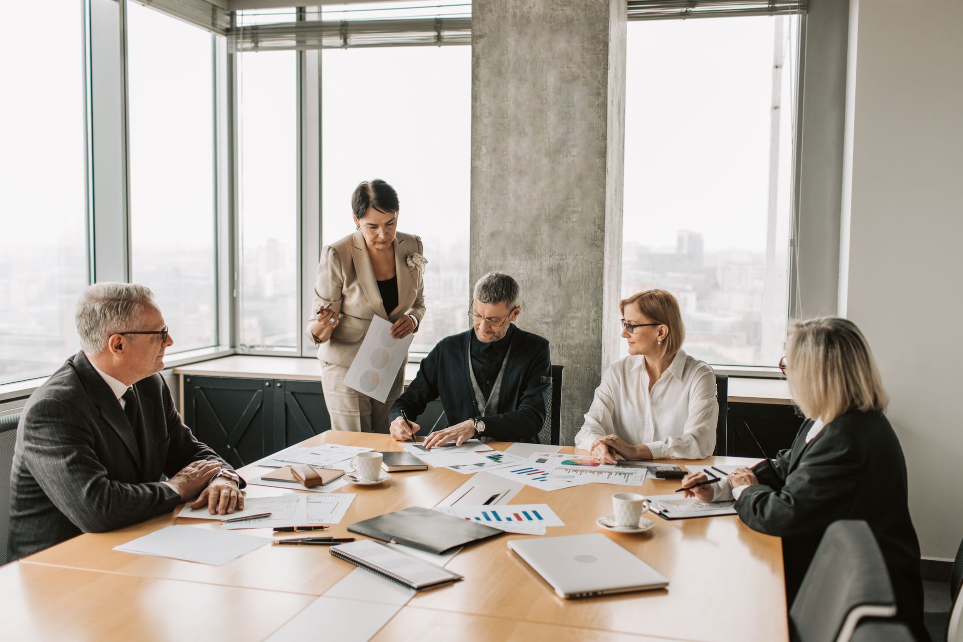 Professionals reviewing documents together at a boardroom table