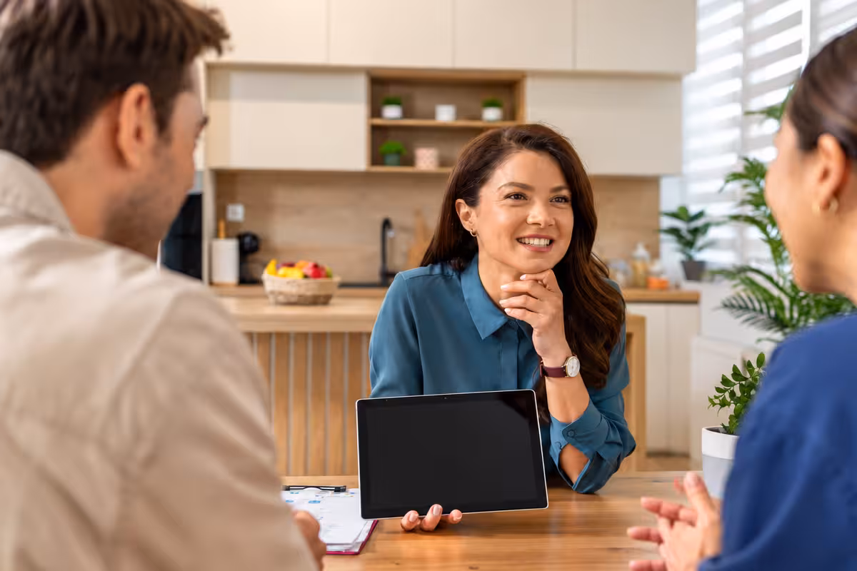 A business discussion around a tablet and financial paperwork